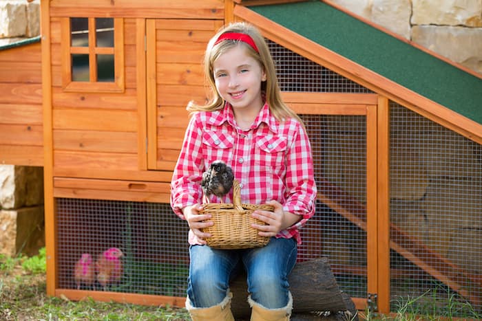 girl by chicken coop